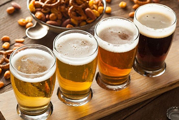 fotografía de 4 vasos llenos de cerveza